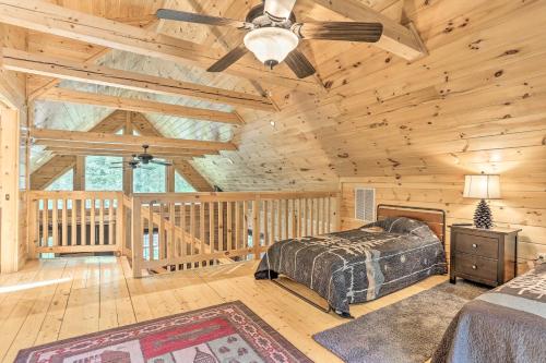 a bedroom with a bed and a ceiling fan at Palmerton Cabin with Game Room about 5 Mi to Blue Mtn in Palmerton