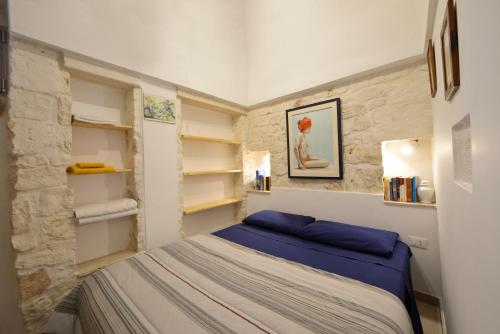 A bed or beds in a room at Ostuni Guest House