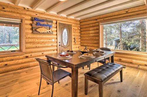 a dining room with a table and chairs in a cabin at Cabin on Kenai Peninsula Family and Group Friendly! in Kenai