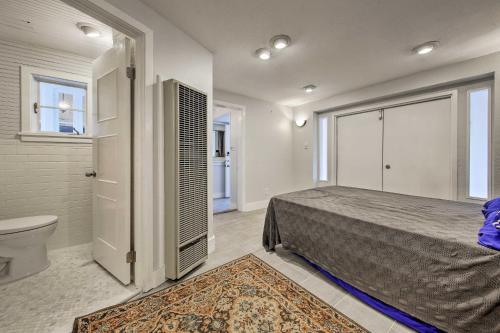 a bedroom with a bed and a bathroom with a toilet at Downtown Austin Apt with Patio, Perfect for Two! in Austin