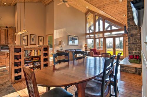 a dining room and living room with a table and chairs at North Shore Cabin with Fire Pit By Gooseberry Falls! in Castle Danger