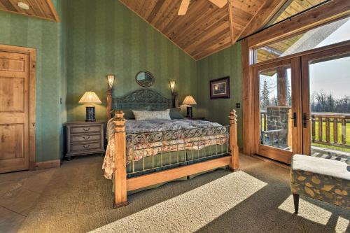 a bedroom with a bed with green walls and a window at North Shore Luxury Cabin By Gooseberry Falls! in Castle Danger