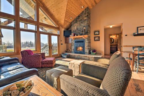a living room with a couch and a fireplace at North Shore Cabin with Fire Pit By Gooseberry Falls! in Castle Danger