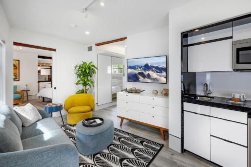 a living room with a couch and a kitchen at Ocean Treasure Beachside Suites in Fort Lauderdale