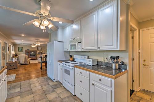 a kitchen with white cabinets and a ceiling fan at 9 Mi to Hot Springs Lake Catherine Home with Dock in Price