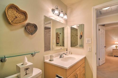 a bathroom with a sink and a toilet and a mirror at Bayfront Condo 3 Mi to Downtown St Petersburg in St Petersburg