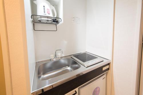 a kitchen with a sink and a stove at Osaka - Hotel / Vacation STAY 65249 in Osaka