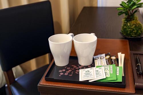 two white cups sitting on a tray on a table at Osaka - Hotel / Vacation STAY 65249 in Osaka