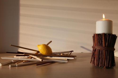 a candle and some matches and a lemon on a table at Residence Ilario Suite Hotel in Riccione