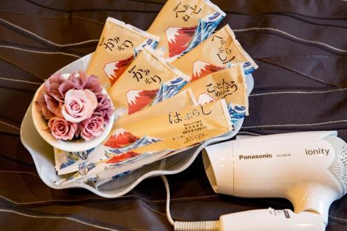 a plate with a bowl of flowers and a hair dryer at Osaka - Hotel / Vacation STAY 65266 in Osaka