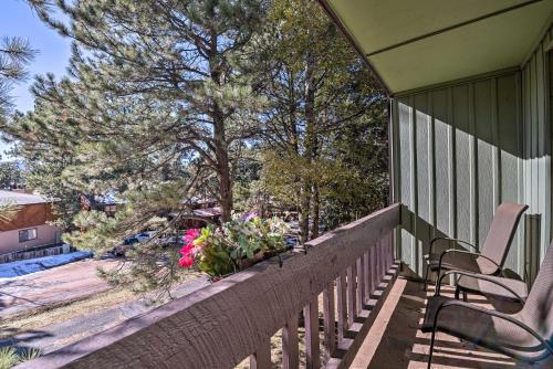 a porch of a house with two chairs and flowers at Angel Fire Mtn Escape Walk to Chile Express Lift! in Angel Fire