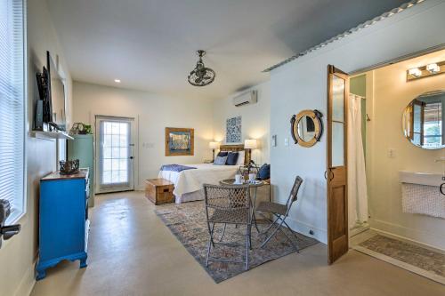 a bedroom with a bed and a table and chairs at Old Town Getaway, Walk to Shopping, Dining, and Bay! in Bay Saint Louis