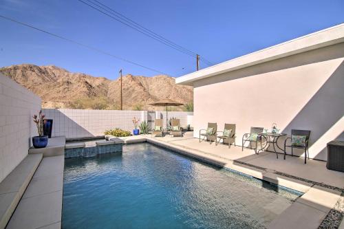 a swimming pool with chairs and a table next to a building at 'Desert Pearl' Oasis with Private Pool - Lower Rates in La Quinta