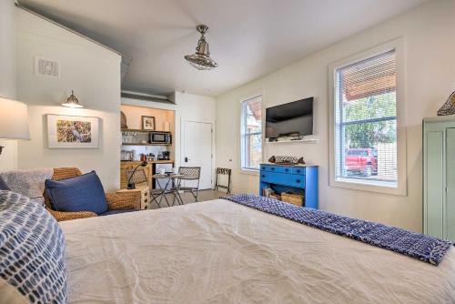 a bedroom with a large bed and a living room at Old Town Getaway, Walk to Shopping, Dining, and Bay! in Bay Saint Louis