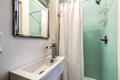 a bathroom with a sink and a shower with a mirror at Walk to Beach from Chic Old Town Apartment with Yard in Bay Saint Louis