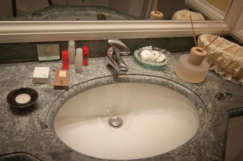 a bathroom sink with a toothbrush holder and a mirror at Residenza Paolo VI in Rome