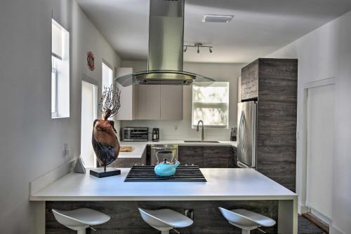 a kitchen with a large island with a vase on it at Modern Miami Villa with Pool Oasis about 5 Mi to Beach! in Biscayne Park