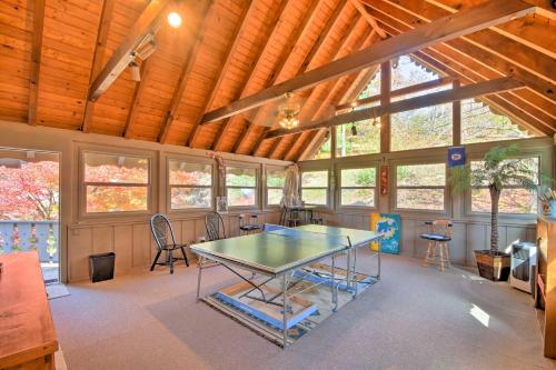 a ping pong table in a room with windows at Picturesque Sky Haus Sanctuary with Mountain Views in Sky Valley