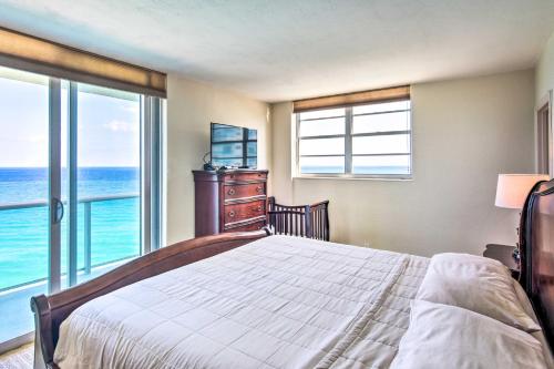 a bedroom with a bed and a view of the ocean at Beachfront Condo with Pool Access in Hollywood! in Hollywood