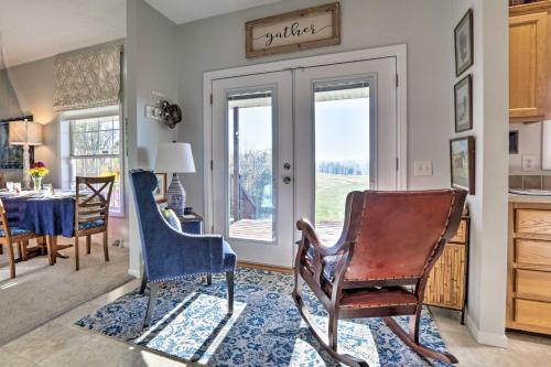 a living room with two chairs and a table at Family Farmhouse on 160-Acre Ranch with Hiking Trail in Lawrenceburg