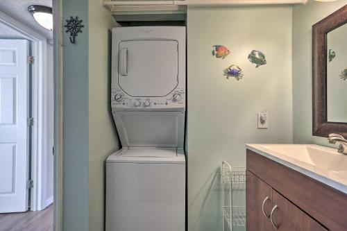 a washer and dryer in a bathroom next to a sink at Myrtle Beach Area Condo - Beachside Fun and Golfing! in Myrtle Beach