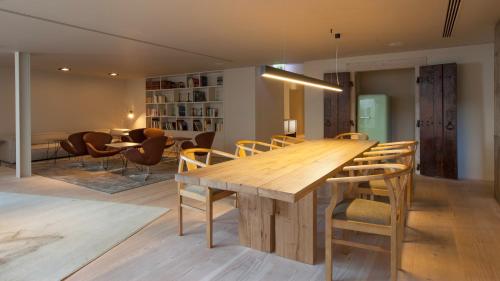 
a dining room table with a wooden table top at Memmo Alfama - Design Hotels in Lisbon
