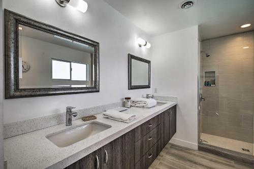 a bathroom with a sink and a mirror and a shower at Mid-Century Modern Oasis, 1 Mile to El Paseo! in Palm Desert