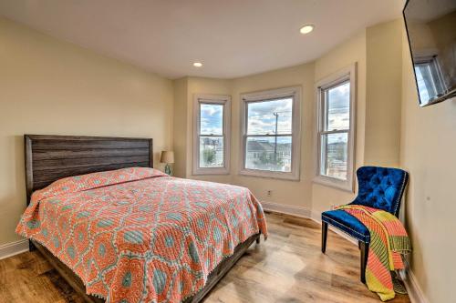 a bedroom with a bed and a chair and windows at Seaside Wildwood Haven Walk to BoardwalkandBeach! in Wildwood Crest