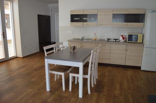 a kitchen with a white table and chairs in a room at Ubytovanie Luky in Bojnice