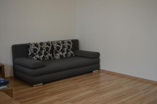 a black couch sitting in a living room at Ubytovanie Luky in Bojnice