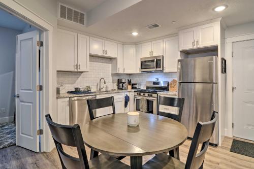 a kitchen with a table and a stainless steel refrigerator at Centrally Located Traverse City Condo 1 Mi to Bay in Traverse City