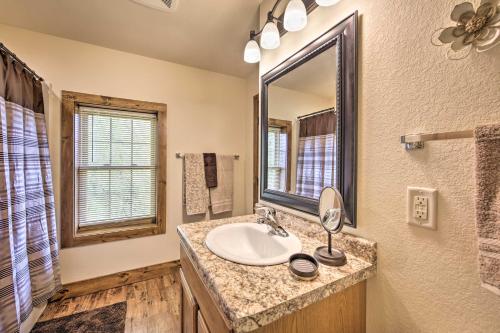 a bathroom with a sink and a mirror at McJuggers Loft Walk to Lake, Park, Restaurants in Campbellsport