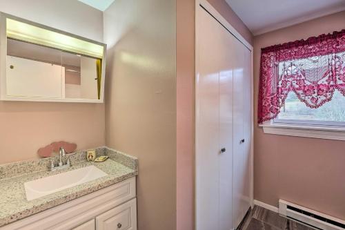 a bathroom with a sink and a mirror at Quiet Catskills Getaway w/ Deck & Mtn Views in New Kingston