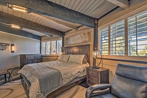 a bedroom with a bed and a chair and windows at Sierra Blanca Mountain Retreat 16 Miles to Ruidoso in Nogal