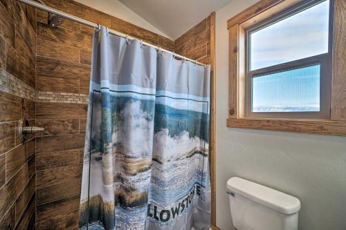 a bathroom with a shower curtain and a toilet at Romantic Mountain Getaway - 1 Hour to Yellowstone! in Livingston