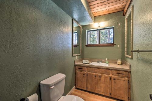 a bathroom with a toilet and a sink and a window at Angel Fire Cabin Less Than 3 Miles to Skiing, Golf and Lake in Angel Fire
