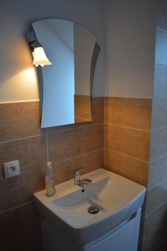 a bathroom with a sink and a mirror at Ubytovanie Luky in Bojnice
