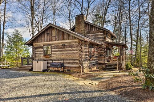 a log cabin in the middle of a forest at Cabin Near Boone with Hot Tub and Mountain Views in Fleetwood