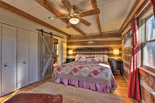 a bedroom with a bed and a ceiling fan at Cabin Near Boone with Hot Tub and Mountain Views in Fleetwood