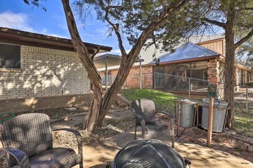 a yard with chairs and a tree and a house at Granbury Getaway with Lake Views 2 Mi to Downtown! in Granbury