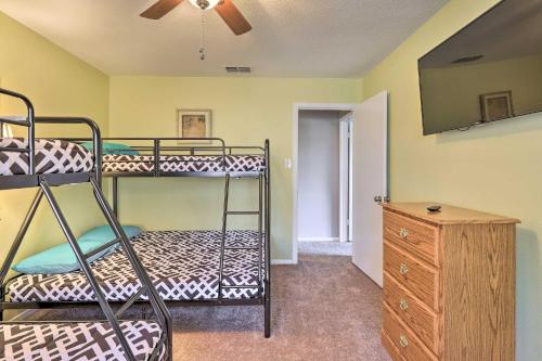 a bedroom with two bunk beds and a dresser at Granbury Getaway with Lake Views 2 Mi to Downtown! in Granbury