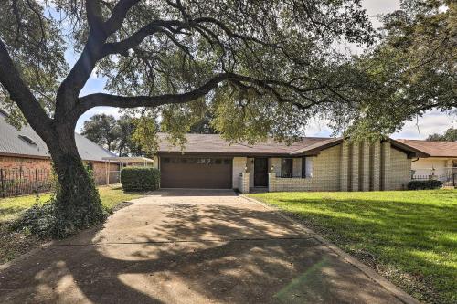 a house with a tree and a driveway at Granbury Getaway with Lake Views 2 Mi to Downtown! in Granbury