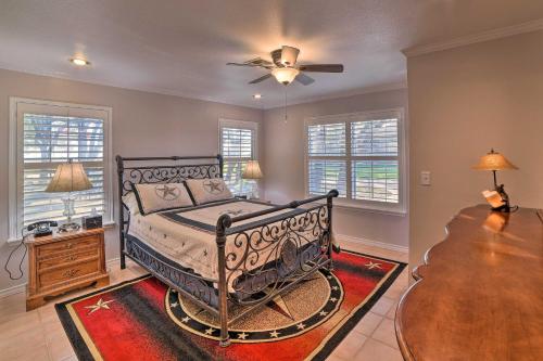 a bedroom with a bed and a table and windows at Casa de Samuel - Patio, Fountain and Outdoor Kitchen in Corpus Christi