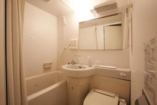 a bathroom with a toilet and a sink and a mirror at Country Hotel Takayama - Vacation STAY 67708 in Takayama