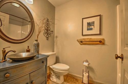 a bathroom with a sink and a toilet and a mirror at White River Getaway with Fire Pit and Trout Fishing! in Mountain View