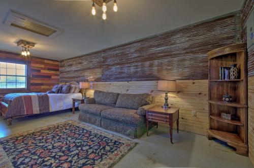 a living room with a couch and a bedroom at White River Getaway with Fire Pit and Trout Fishing! in Mountain View