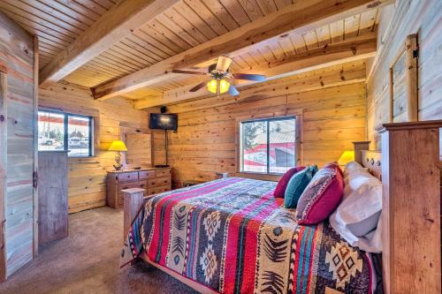 a bedroom with a bed in a log cabin at Pet-Friendly Cloudcroft Cabin Walk to Shop, Food in Cloudcroft