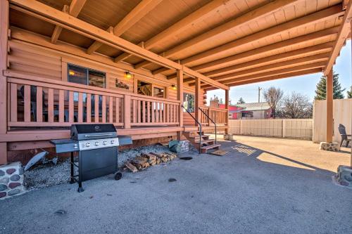 a wooden cabin with a grill and a house at Pet-Friendly Cloudcroft Cabin Walk to Shop, Food in Cloudcroft