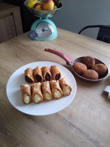 a plate of pastries and muffins on a table at Bed, Book & Breakfast Landolina in Catania