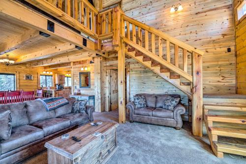 a living room with couches and a staircase in a cabin at Pet-Friendly Cloudcroft Cabin Walk to Shop, Food in Cloudcroft